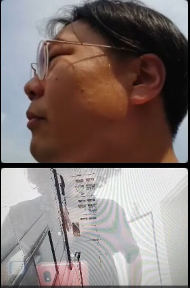 vertical split-screen. the top half shows a bespectacled Koujiro looking to the side. The bottom half is a composite of stephan in his apartment and an outside camera showing the space between two apartment buildings