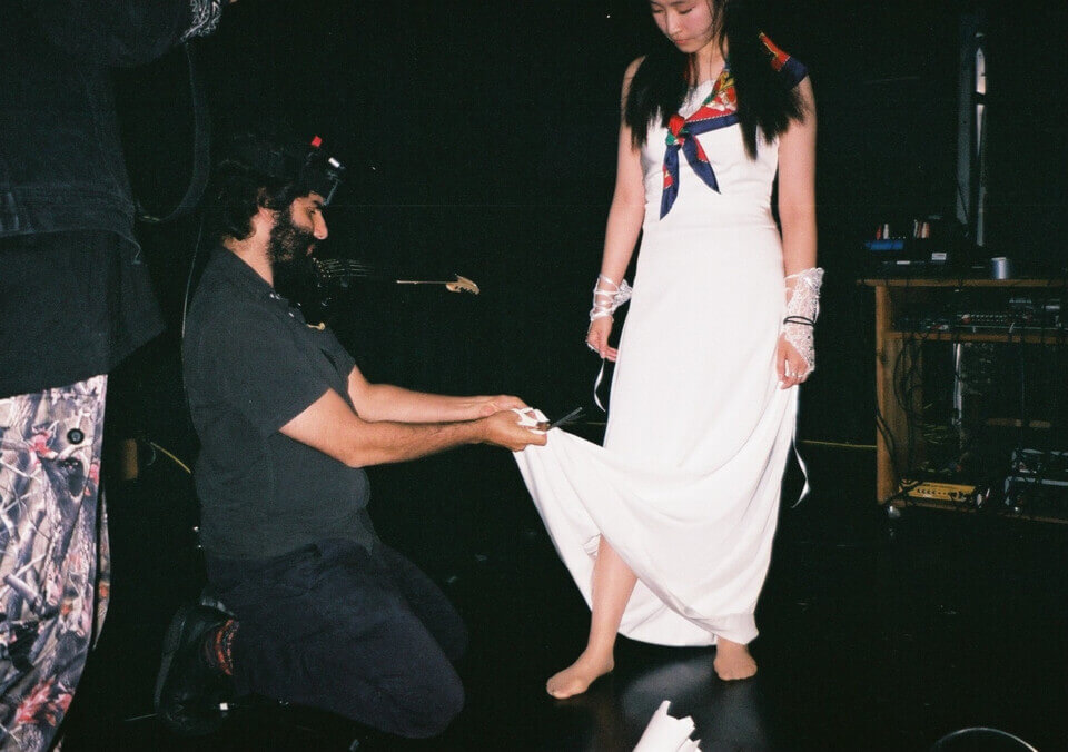 disposable camera shot of stephan cutting akari's dress with a pair of scissors